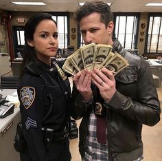 a police officer and a woman holding cash