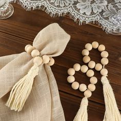 two bags with tassels are sitting next to each other on a wooden table