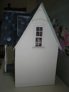 there is a doll house with a blue roof