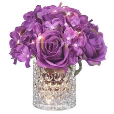 a vase filled with purple flowers on top of a table