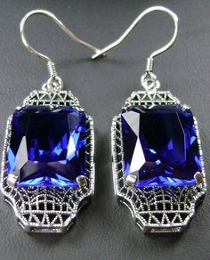 "Simulated Blue Sapphire Earrings Lantern Design#E13 Custom Made Inspired by the Art Deco movement of the early 1900s, I now offer these lovely Antique reproduction earrings in sterling silver. These earrings were refashioned from an Antique Art Deco brooch. Each stunning 9ct Simulated Blue Sapphire is 15mm long (just over 9/16\") and 12mm in width (1/2th\"). The earrings are 1 3/4th inch long and 9/16th at their widest. I often also sell the matching pendant. A gift box is included and all item Retro Blue Drop Earrings Jewelry, Classic Blue Drop Earrings, Blue Rectangular Jewelry For Party, Vintage Blue Drop Earrings Jewelry, Classic Rectangular Party Earrings, Handmade Rectangular Earrings For Formal Occasions, Classic Rectangular Evening Earrings, Vintage Sapphire Jewelry For Formal Occasions, Vintage Blue Drop Earrings