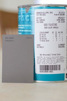 a can of food with a label on it next to a small piece of paper