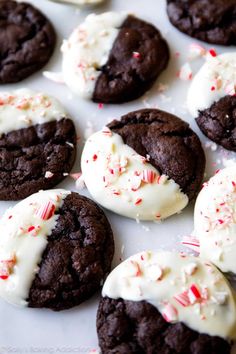 chocolate cookies with white frosting and sprinkles