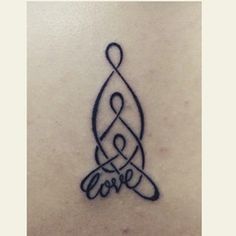 a tattoo with the word love written in cursive writing