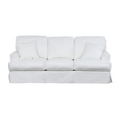 a white couch with four pillows on it