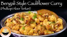 a bowl filled with cauliflower curry on top of a table