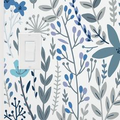 the light switch cover is decorated with blue and gray flowers, leaves, and branches