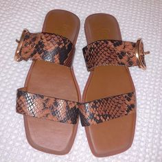 Genuine Leather Snake Embossed Slide Sandals With Buckle Detail. An Oversized O-Ring Buckle Adds A Fun Element To This Double Strap Vamp Sandal Slides. 0.5" Heel Slip On Leather Upper, Synthetic Lining, Synthetic Sole Brand New, Never Worn But Some Visible Wear On The Top Soles From Being On Display. See Pictures For Reference. Brown Faux Leather Sandals With Round Toe, Brown Faux Leather Open Toe Sandals, Brown Flat Sandals With Buckle Closure, Flat Brown Leather Sandals, Brown Faux Leather Sandals For Vacation, Brown Faux Leather Flat Sandals, Brown Flat Faux Leather Sandals, Brown Leather Flat Sandals, Leather Open Toe Sandals With Snake Print