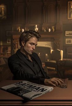 a man sitting at a table in front of a book