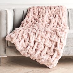 a couch with a pink blanket on top of it