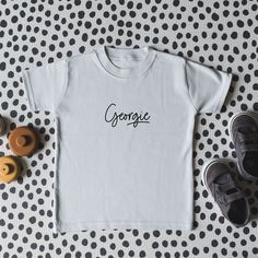 A beautiful, soft t-shirt featuring your little one's name in a fun, underlined script font. Please enter your personalisation in the box (making sure that you triple-check the spelling. Available in different colour combinations to match any outfit. Please double-check the sizing (found in images) before ordering to make sure you are confident of the fit. 100% Cotton. Oeko-Tex Standard 100 certified, meaning that it does not contain harmful substances. Wash according to the label. Not suitable for tumble drying. See other listings for this design on baby grows. Peach Shorts, Top Kids, Adventure Gifts, Children Top, Box Making, Valentines Day Weddings, Script Font, Personalised Kids