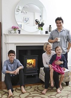 a family sitting in front of a fire place