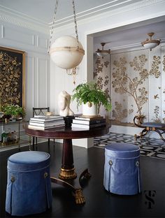 an elegant dining room with blue stools