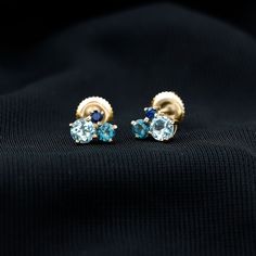 Product Details These Three Stone Stud Earrings embellished with Round Shape Sky Blue Topaz, London Blue Topaz and Blue Sapphire Gemstones are set in a Prong Setting. Product Information SKU SHP-EARRINGS102025073 Length 6 mm Width 7.2 mm Height 3.2 mm Weight 0.88 gm (Approximate) BLUE SAPPHIRE INFORMATION No.of Stones 2 Pieces Total Weight 0.10 Carat (Approximate) Dimension(approx) Round-2X2 mm-2 Pcs Color Blue Cut Brilliant Shape Round Setting Type Prong-Setting Quality Grade AAA LONDON BLUE TO Formal Blue Birthstone Earrings, Blue Topaz Multi-stone Earrings, Blue Birthstone Earrings For Formal Occasions, Blue Prong Set Fine Jewelry Earrings, Blue Round Cluster Earrings For Formal Occasions, Anniversary Blue Topaz Multi-stone Earrings, Fine Jewelry Blue Topaz Earrings With Gemstone Accents, Multi-stone Blue Topaz Earrings As Gift, Anniversary Multi-stone Blue Topaz Earrings