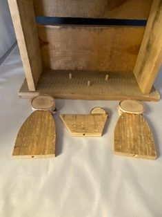 two pieces of wood sitting next to each other on a white tablecloth covered surface