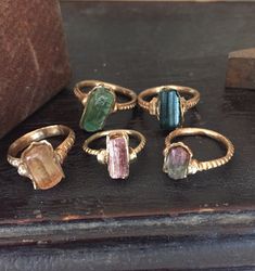 Recycled 14k gold and raw tourmaline crystal rings by PhBeads. Gold Ring With Raw Stone For Healing, Tourmaline Natural Stones Ring Jewelry, Tourmaline Natural Stones Ring, Tourmaline Ring With Natural Stones, Bohemian Rings With Raw Stone For Healing, Bohemian Raw Stone Rings For Healing, Bohemian Raw Stone Healing Rings, Gold Tourmaline Rings, Handmade Tourmaline Gold Ring