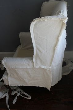 a chair that has been torn apart and is sitting on the floor next to a pile of toilet paper