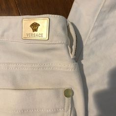 28 In Waist Versace White Designer Jeans Trousers With Gold Bling Embellishments Gianni Versace 98% Cotton 2% Elastane - Fabric Is Very Soft And Comfy Retails For $700 Brand New No Tag, Never Worn. Has Minor Stains That Should Come Out From Washing Them- Hard To Capture With The Camera Tag Says Dry Clean . Do Not Wash . Cool Iron. 28 Inch Waist Per Tag Approximate Measurements 15.75 Inch When Measuring Waist With Pants Laid Flat 8 Inch Rise - Medium Rise 29 Inch Inseam 8 In - Wide Of Leg Opening Luxury White Straight Leg Bottoms, Measuring Waist, 28 Inch Waist, Bling Design, Versace Jeans Couture, Versace Jeans, Gianni Versace, Designer Jeans, Trouser Pants