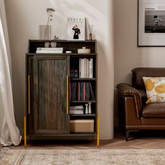 a brown chair sitting next to a book shelf