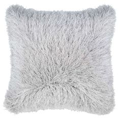 a gray pillow with fluffy fur on it