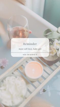 a baby is sitting in a bathtub with flowers on the side and an empty bottle next to it