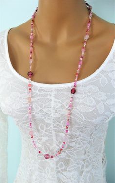 "This Pink Eyeglass Chain can also be worn as a necklace. Ralston Originals was the first to add the lobster clasp at the end of the eyeglass chain to join it together to make a Necklace. Brilliant! This makes it even more convenient because you now have two pieces of jewelry in one, and eyeglass chain for your glasses, and a beaded necklace!! The chain is made with an assortment of sizes and colors of pretty pink glass beads, and pink seed beads. The ready made chain is 26 or 32 inches long, or Pink Glass Necklace With Round Beads, Pink Czech Glass Necklaces With Colorful Beads, Handmade Pink Czech Glass Necklaces, Handmade Glass Long Necklace For Gift, Pink Single Strand Glass Necklace, Handmade Pink Czech Glass Necklace, Elegant Pink Glass Beaded Necklaces, Elegant Pink Glass Beaded Necklace, Beaded Glass Long Necklace As A Gift