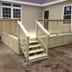 a wooden deck with steps leading up to it