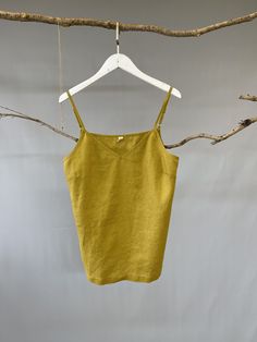 "Adorable camisole top by Nature Chic. 100% linen construction, this slip top is simply the best. Relaxed fit, straight cut, adjustable spaghetti straps, and classic V neckline, all these elements work together to create a versatile essential top. It is not only good for summer but also nice for fall underneath a shirt or jacket. -Prewashed linen -Straight cut but roomy -V-neck -Adjustable spaghetti straps sitting neatly at shoulders -Length and bottom hem suitable for tucked-in or un-tucked. -S Summer Linen Tank Top With Adjustable Straps, Summer Linen Camisole Tank Top, Linen Tank Camisole For Beach, Linen Sleeveless Camisole With Adjustable Straps, Beach Linen Tank Camisole, Beach Tank Linen Camisole, Solid Linen Summer Tank Top, Spring Linen Camisole, Spring Linen Summer Camisole