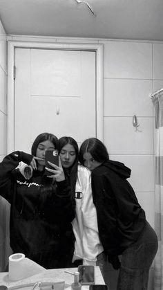 three women taking a selfie in the bathroom