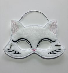 "Cat/Kitty Masks. Great for dramatic play/dress-up. Fun mask for Halloween or Cos Play. These masks would make a fun party favor or fun addition to a themed birthday party. Need a larger quantity than what I have listed? Message me. I can usually accommodate larger orders. These masks are made from felt. The details are machine embroidered. The masks include a 13\" elastic strap. This size typically fits from age 3 to small adult. This mask measures approximately 7 by 5 inches. These items can b Fun Party Mask Costume Accessory, Cute White Party Costumes, White Themed Party Costumes, Cat Ears Costume Accessories For Costume Party, Novelty Cat Design Costume Accessories For Party, Halloween Party Costume Accessories With Cat Design, Cat Design Novelty Party Costume Accessories, White Themed Costume Accessories With Cat Ears, Fun White Costume Accessories For Halloween