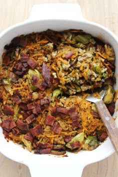 a casserole dish with bacon, cheese and brussels sprouts in it