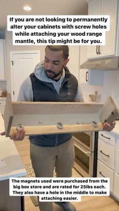 a man holding up a wooden box in the kitchen with instructions on how to make it