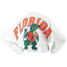 Whether you're a current student, alumni or just a superfan, every member of the Florida Gators franchise needs a solid collection of gear. This season, spruce up your look with this chic Raw Hem Cropped Spirit Jersey T-shirt! The fierce Florida Gators graphics and super-soft blend make this fun top a must-have addition to your closet! Brand: Spirit Jersey Raw hem Officially licensed Material: 100% Cotton Long sleeve Rib-knit collar and cuffs Machine wash, tumble dry low Screen print graphics Ma Varsity Crew Neck Top With Team Logo, Collegiate Crew Neck Tops For Streetwear, School Spirit Tops With Team Logo For Fan Gear, Team-colored Tops With University Logo For Fans, Team-colored University Logo Tops For Fans, Collegiate Tops With University Logo For Game Day, College Fan Apparel Sweatshirt With Logo Print, Collegiate Tops With University Logo, Collegiate Graphic Print Sweatshirt For Fan Merchandise