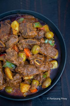 a plate full of meat and vegetables on a table