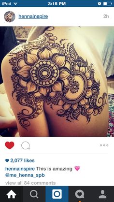 a woman's stomach with an intricate tattoo design on the side of her body