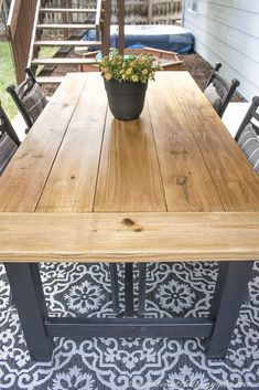 a wooden table sitting on top of a patio