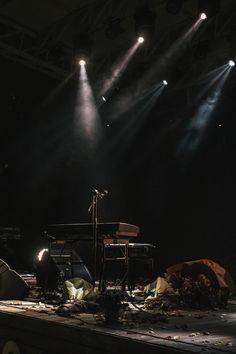 the stage is set up for a concert with lights on and music equipment scattered around