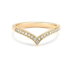 a yellow gold ring with white diamonds on the side and a curved band in the middle