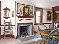 a dining room with a fireplace and chairs