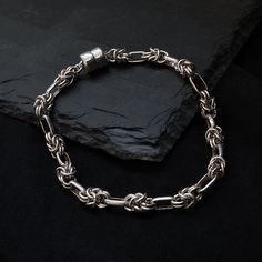 Like a serpent, this sleek high polish bracelet is chained together creating knot-like structure. Sits comfortably and smoothly against your wrist. Comes with a magnetic clasp which makes it very easy to put on. It can be worn alone or layered with other bracelets and cuffs. Materials: Sterling silver Round magnetic clasps High polish finish ** Tippy Taste Men's are made-to-order. Please allow 1-2 week turnaround time. ShippingDomestic: Free standard shipping within the U.S.International: Free s Knot Bracelet, Magnetic Clasp, Stylish Men, Chain Bracelet, Knot, Chain Necklace, Sleek, Cuff, Bracelet