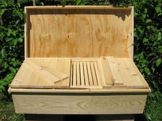 an open wooden box sitting in the grass