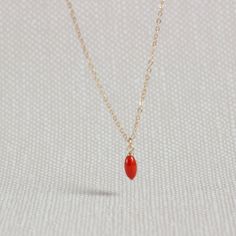 This simple necklace made of 14k Gold Fill carries a small coral bead in a beautiful orange red. Its feminine and minimalist design makes this necklace a modern and elegant accessory for every day. It also looks very pretty layered with other necklaces. D E T A I L S - Necklace: 14k Gold Fill - Gemstone: Coral, 3 x 7 mm - Custome-made by Janine - Beautifully wrapped - Handmade in Germany ♥ Find more Coral jewelry here: https://www.etsy.com/de/shop/KelilaJewelry?ref=seller-platform-mcnav&search_q Minimalist Orange Jewelry For Gifts, Minimalist Orange Necklace As Gift, Minimalist Red Necklace With Delicate Chain, Red Minimalist Necklace With Delicate Chain, Minimalist Red Pendant Necklace, Red Minimalist Pendant Necklace, Handmade Gold Necklace With Red Coral, Red Coral Pendant Jewelry For Gift, Coral Pendent Gold