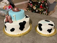 two decorated cakes sitting on top of a counter