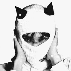 black and white photograph of a woman wearing a cat mask with stars on her ears