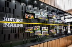 the inside of a building that has many posters on it and yellow tape in front of it