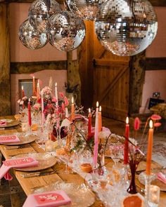 a long table with plates and candles on it