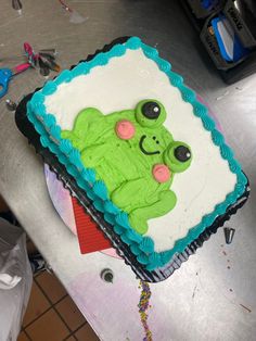 there is a cake that looks like a frog on the table