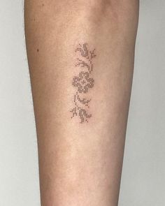 a woman's leg with a tattoo on it that says love and is written in small letters