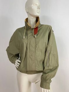 "90s spring jacket, beige jacket, size men's small Measurements:  Shoulder 18\"-21\"/sleeve 22\"/bust (pit-pit)23\"/length 24\"/bottom width 15\"-21\" Mannequin measurements:  5'8\", bust 34\", waist 25\", hip 33\" Please note that vintage clothing sizes can vary greatly.  The Measurements provided  are approximate and are taken lying flat.  I suggest taking a similar garment from your wardrobe and measure it while lying flat.  This way you can compare measurements.  All of our pieces are genuin Luxury Single-breasted Vintage Utility Jacket, Beige Military Style Long Sleeve Outerwear, Urban Style Windbreaker With Stand Collar For Spring, Fitted Windbreaker For Spring Outdoor, Fitted Windbreaker For Spring Outdoor Activities, Fitted Spring Windbreaker For Outdoors, Military Style Spring Windbreaker For Outdoor, Spring Military Outerwear With Stand Collar, Khaki Stand Collar Windbreaker For Fall