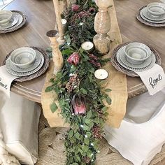 the table is decorated with greenery and candles